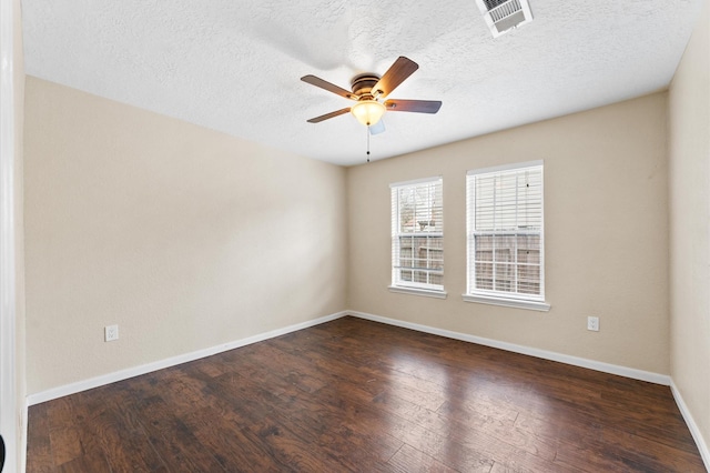 spare room with ceiling fan, dark wood-type flooring, and a textured ceiling