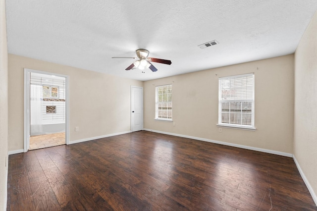 spare room featuring a textured ceiling, ceiling fan, and dark hardwood / wood-style floors