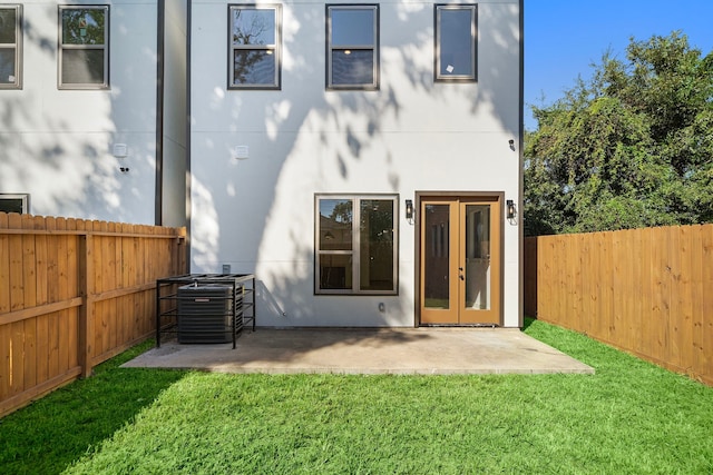 back of property with cooling unit, a yard, and a patio