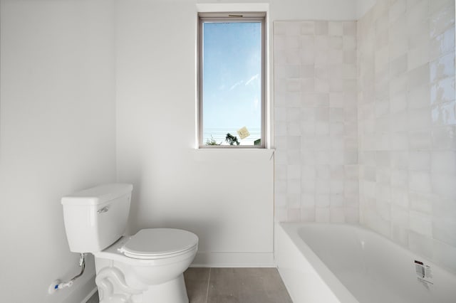 bathroom with a bathing tub, toilet, and wood-type flooring