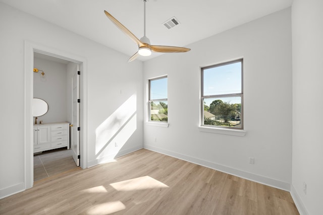 spare room featuring ceiling fan and light wood-type flooring