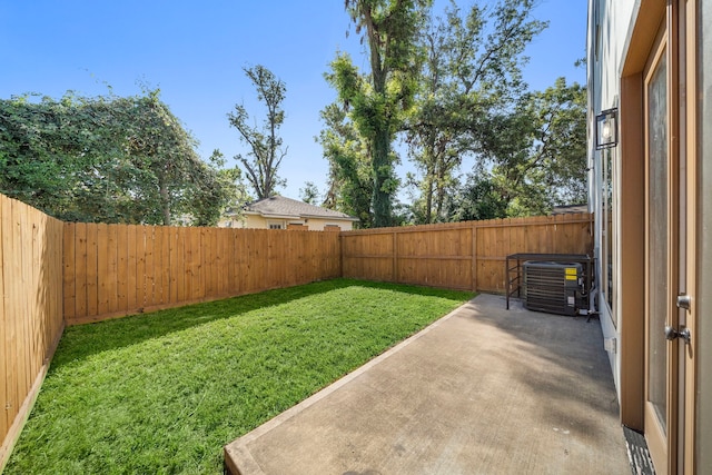 view of yard featuring central AC and a patio area