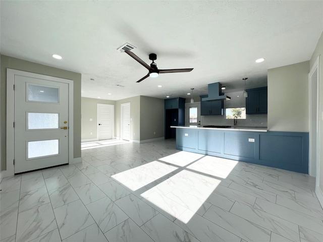 kitchen featuring ceiling fan and range hood