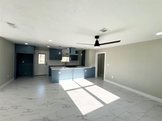 kitchen with kitchen peninsula, a textured ceiling, ventilation hood, ceiling fan, and sink