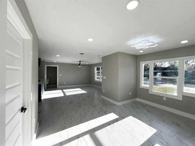 spare room featuring ceiling fan and a textured ceiling