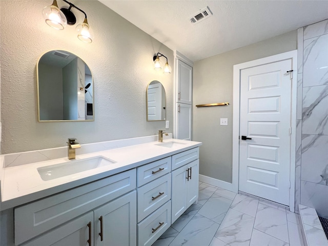 bathroom with vanity and a textured ceiling