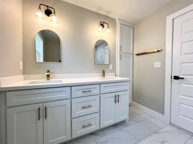 bathroom with vanity and a textured ceiling