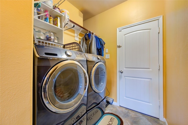 laundry area featuring tile patterned flooring and washer and clothes dryer