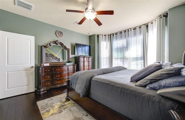 bedroom with ceiling fan and dark hardwood / wood-style flooring