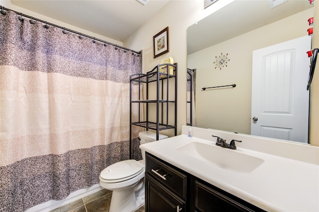 bathroom with tile patterned flooring, vanity, and toilet