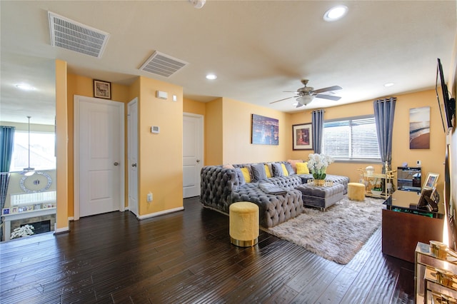 living room with ceiling fan and dark hardwood / wood-style flooring