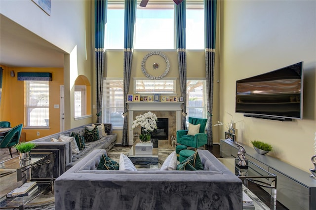 living room featuring a tile fireplace and hardwood / wood-style floors