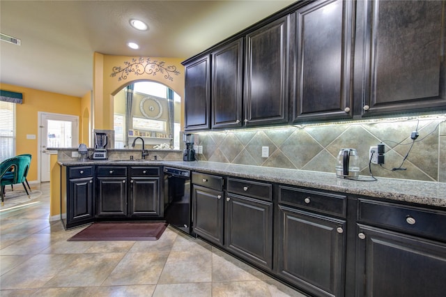 kitchen featuring kitchen peninsula, tasteful backsplash, sink, light tile patterned floors, and black dishwasher