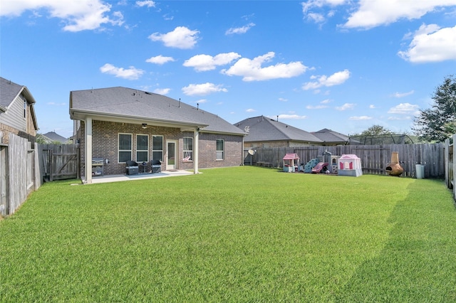 back of property featuring a patio area and a lawn