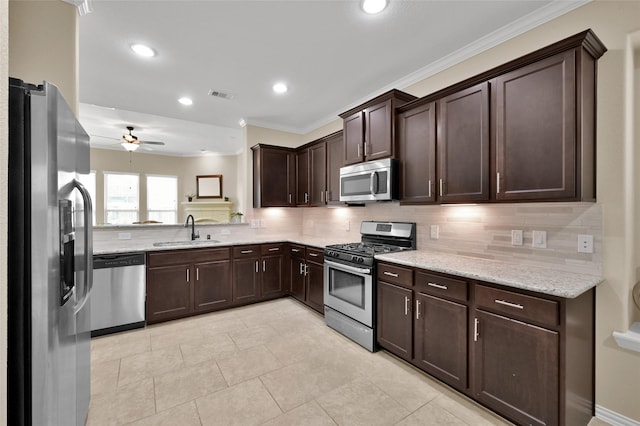 kitchen featuring sink, decorative backsplash, ornamental molding, light stone counters, and stainless steel appliances