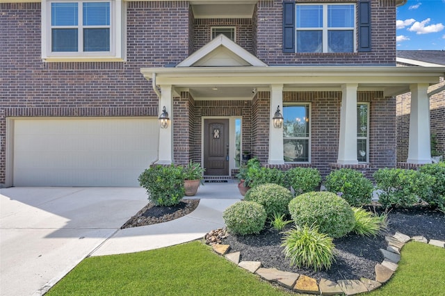 doorway to property with a porch and a garage