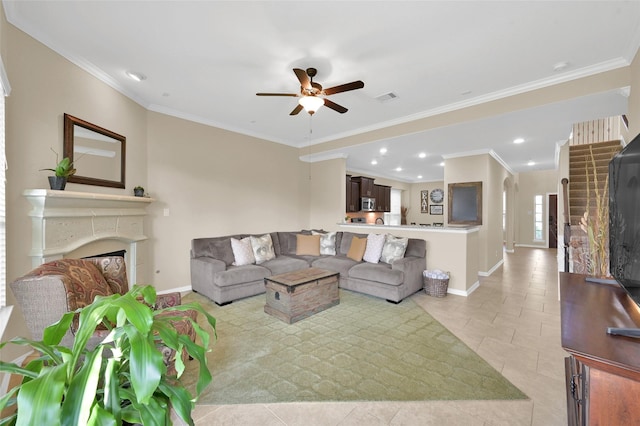 tiled living room with ornamental molding and ceiling fan