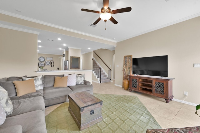 tiled living room featuring ornamental molding and ceiling fan