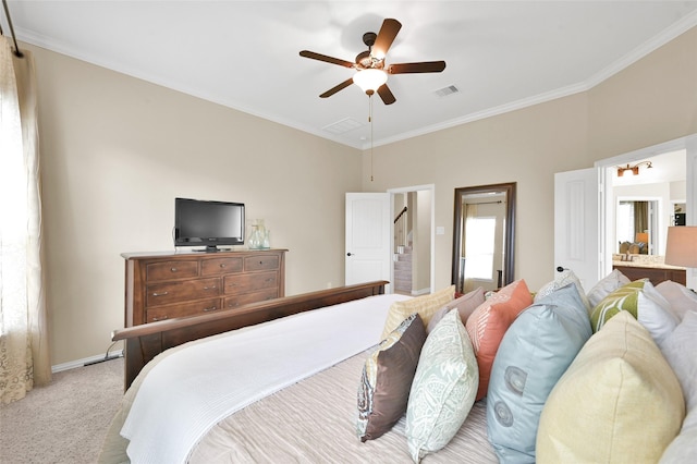 carpeted bedroom featuring ornamental molding, connected bathroom, and ceiling fan