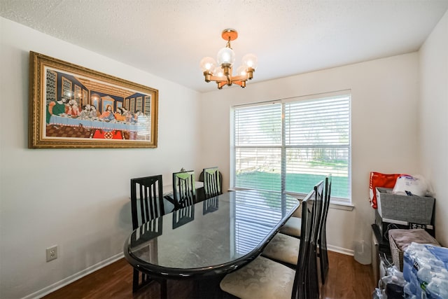 dining space with dark hardwood / wood-style flooring and a notable chandelier