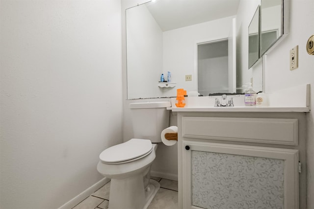 bathroom featuring toilet, vanity, and tile patterned floors