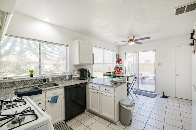 kitchen with kitchen peninsula, black dishwasher, white cabinets, and a wealth of natural light