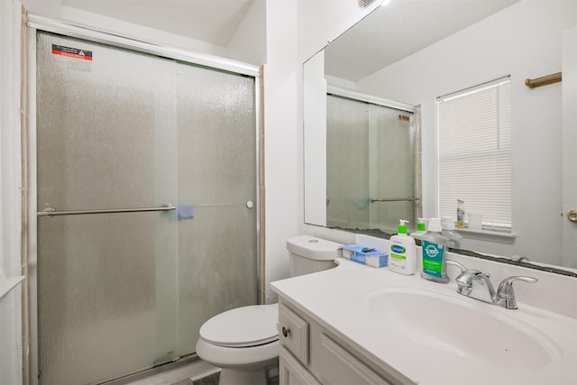 bathroom featuring toilet, an enclosed shower, and vanity