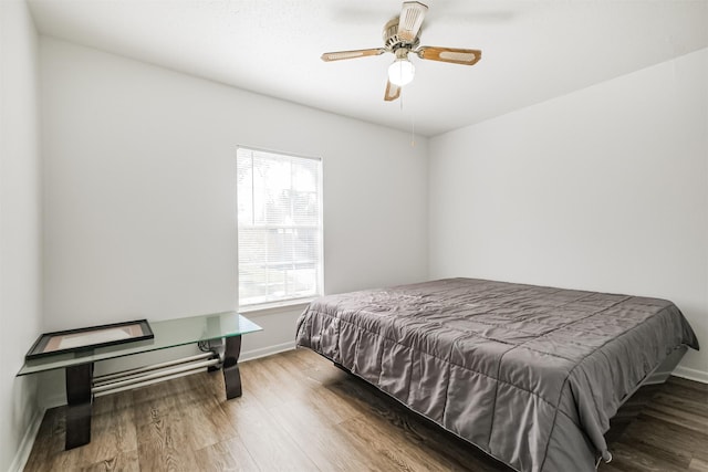 bedroom with wood-type flooring and ceiling fan