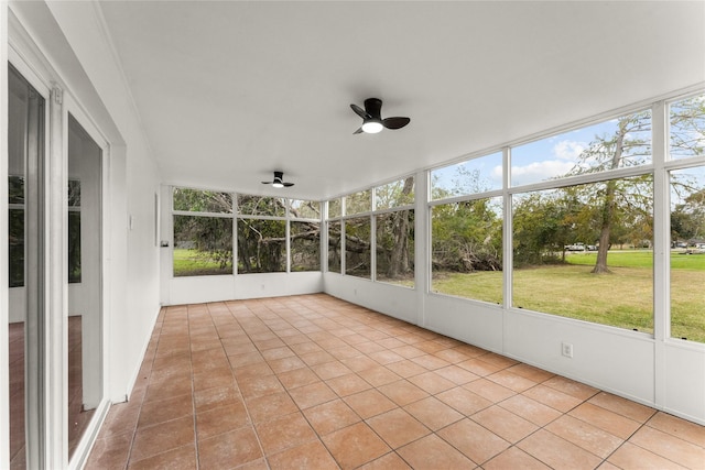 unfurnished sunroom with ceiling fan