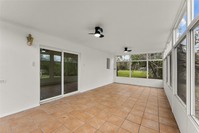 unfurnished sunroom with ceiling fan