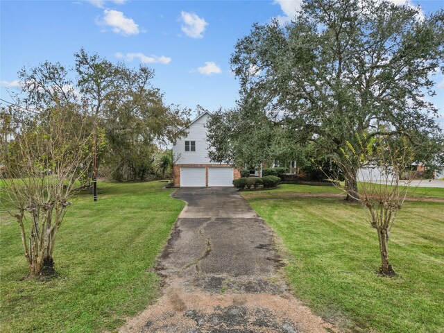 view of front of house with a front yard and a garage