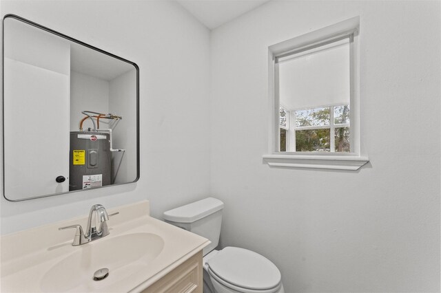 bathroom with vanity, toilet, and water heater