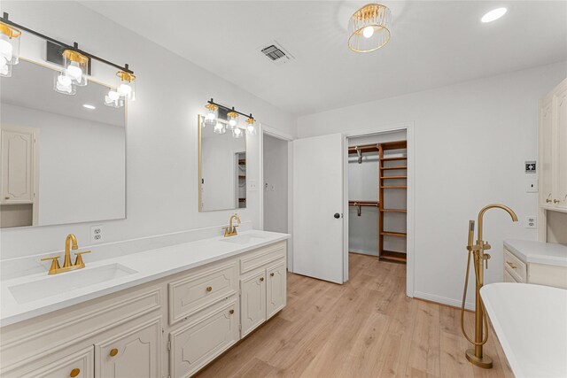 bathroom featuring a bathtub, vanity, and hardwood / wood-style flooring