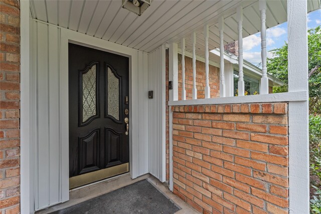 view of exterior entry with a porch