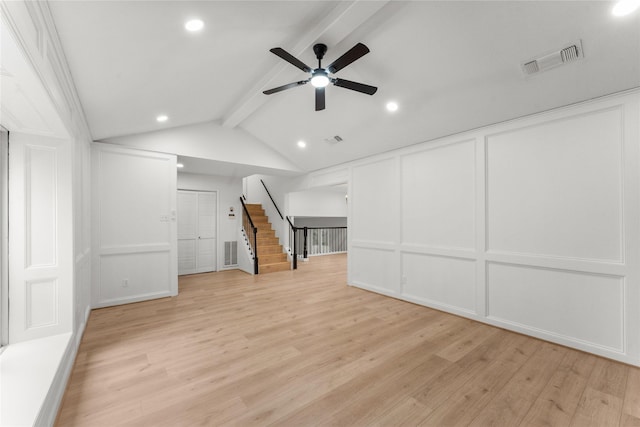 unfurnished living room with ceiling fan, lofted ceiling with beams, and light wood-type flooring