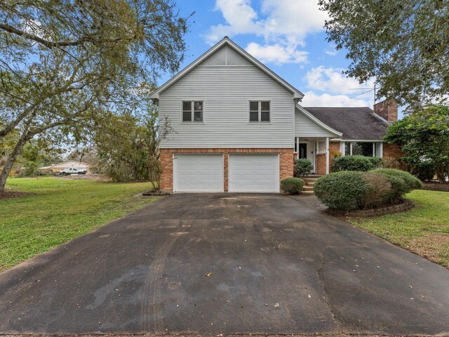 tri-level home featuring a front lawn and a garage