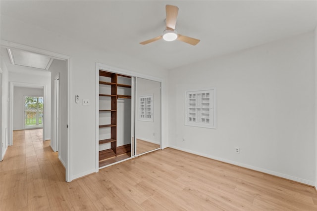 unfurnished bedroom with light wood-type flooring, a closet, and ceiling fan