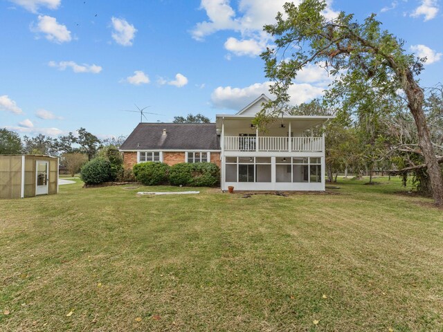 back of property with a yard and an outbuilding