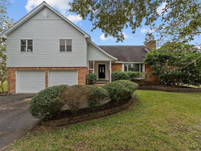 split level home with a garage and a front lawn