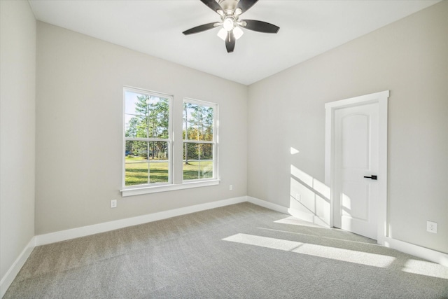 carpeted spare room featuring ceiling fan