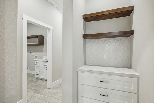 hallway with baseboards and wood finish floors