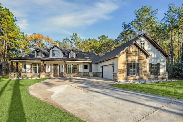 view of front facade featuring a garage, stone siding, concrete driveway, and a front lawn