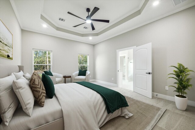 bedroom with carpet floors, a raised ceiling, ceiling fan, and crown molding