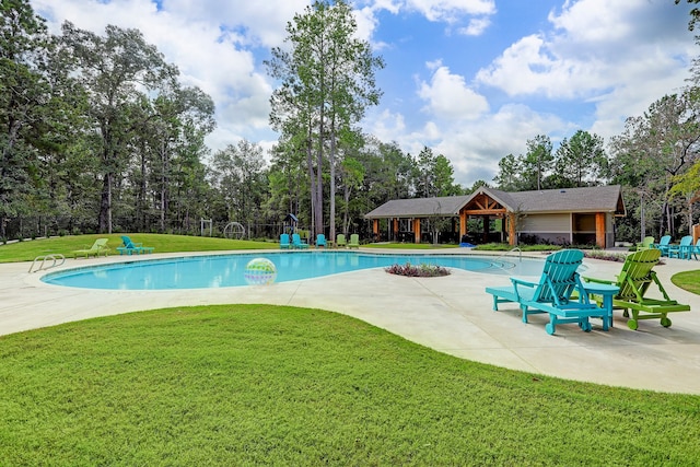 pool featuring a yard and a patio