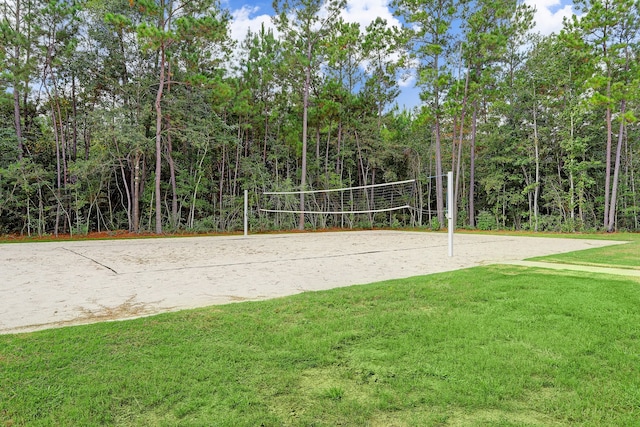 view of community featuring a lawn and volleyball court