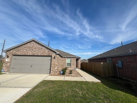 view of front of house with a garage and a front lawn