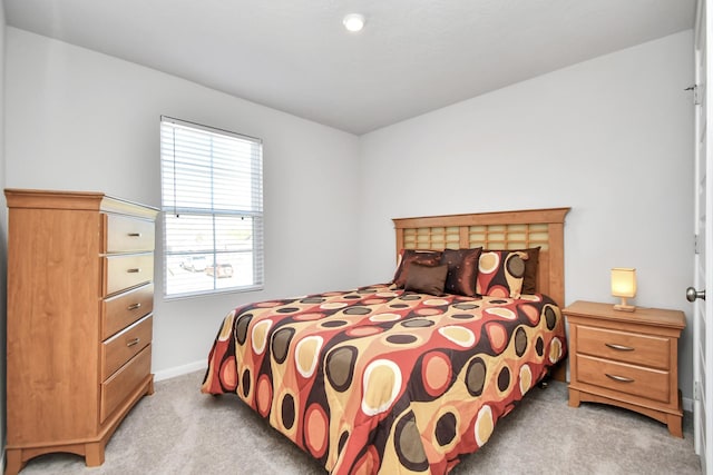 bedroom featuring light carpet