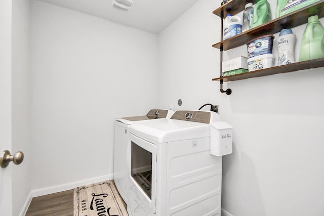 clothes washing area with hardwood / wood-style flooring and washing machine and clothes dryer