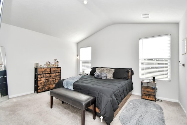 carpeted bedroom featuring lofted ceiling