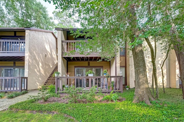 back of house featuring a balcony